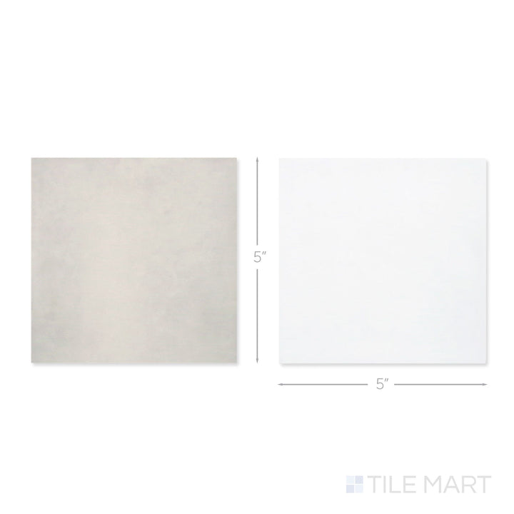 Top-down view of a single Village 5x5 white and silver mist checkerboard glossy ceramic tile showing its light-reflective surface and two-tone finish detail