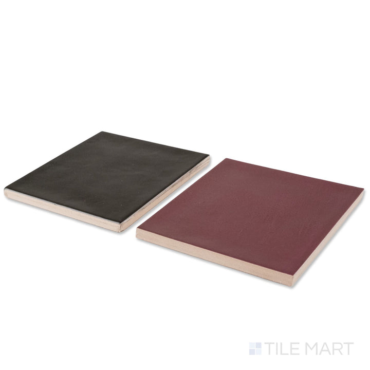 Corner shot of Village 5x5 aubergine and black checkerboard glossy ceramic tile revealing its edge profile and glossy aubergine and black surface