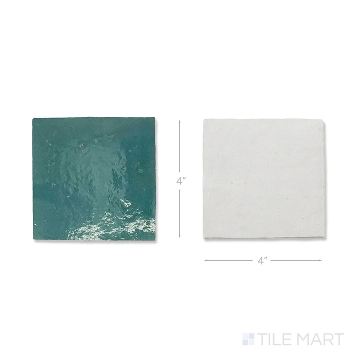Flat lay of a single Zellige Classique tile in Lambswool and Blue City, showing the glossy hand cut glaze up close.