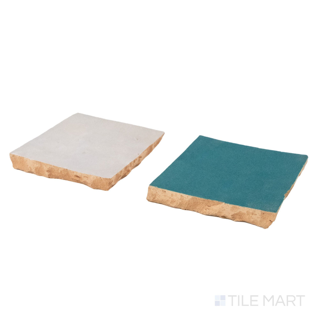 Corner shot of Zellige Classique tile in Lambswool and Blue City, revealing its hand cut edge and light-catching glaze.