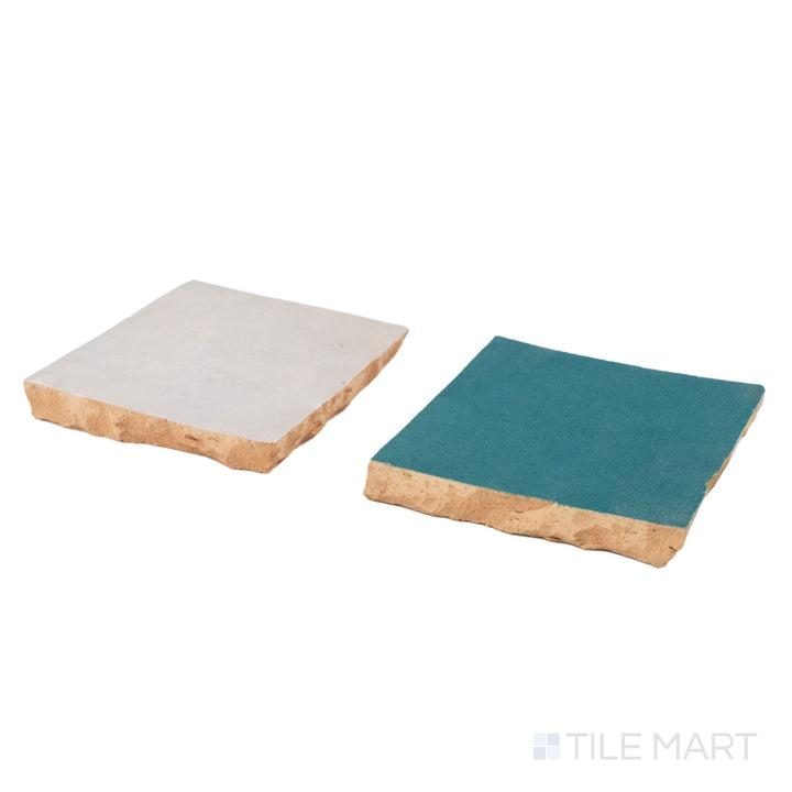 Corner shot of Zellige Classique tile in Lambswool and Blue City, revealing its hand cut edge and light-catching glaze.
