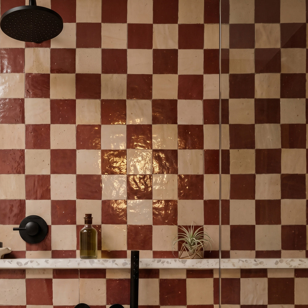 Zellige Classique in Sahara Rose and Al Hamra brings artisan glaze variation and vibrant color to a checkerboard wall.