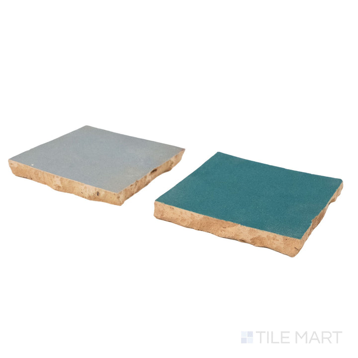 Corner shot of Zellige Classique tile in Gris Perle and Blue City, revealing its hand cut edge and light-catching glaze.
