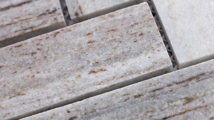 Video of Sto-Re Ocean White Herringbone Polished Marble Mosaic. A sleek Ocean White marble mosaic featuring a polished herringbone pattern.