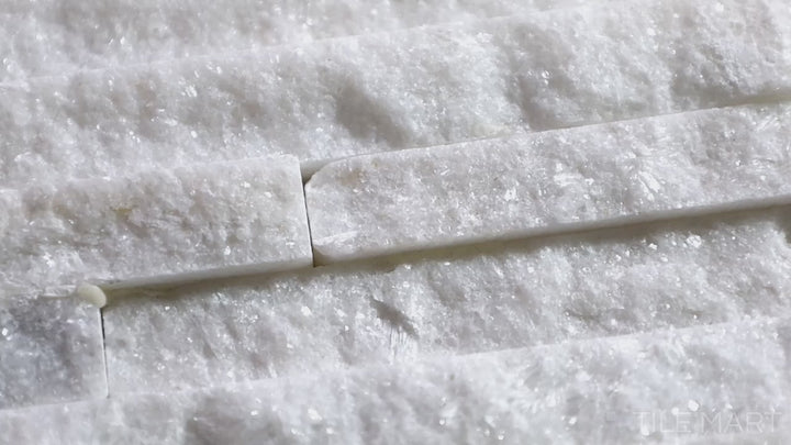 Video highlighting Contemporary Mini Ledgestone Snowfall 6x24 Natural Stone. A bright white natural stone tile with a stacked ledgestone design, bringing a fresh and elegant appeal.