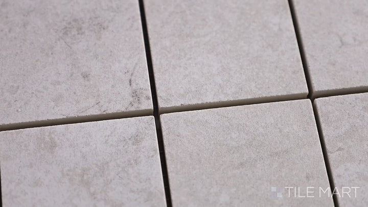 Video of Epika Ivory 2-inch Square Matte Porcelain Mosaic. A soft ivory porcelain mosaic with a matte texture, creating a subtle and refined visual effect.