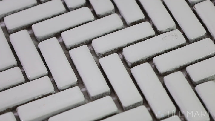 Video of Foundations Plaster Herringbone Tilt Glossy Ceramic Mosaic. A stylish glossy ceramic mosaic with a tilted herringbone design, perfect for modern and elegant interiors.