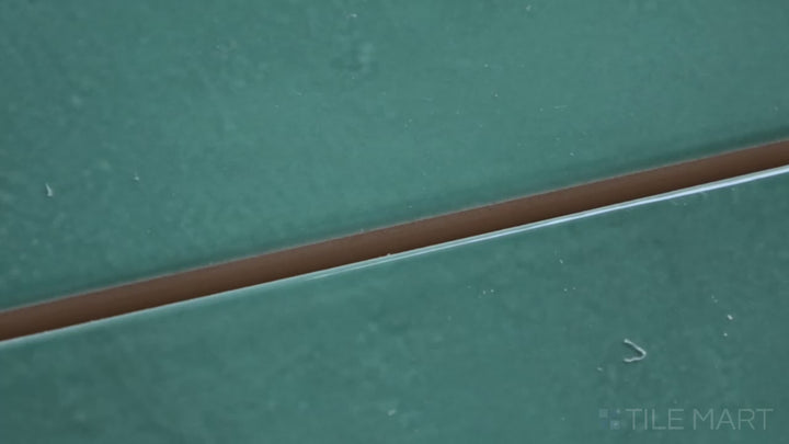Video showcasing Village Emerald Green 2.5X8 Glossy Ceramic. A rich green subway tile with a luminous glossy sheen, perfect for vintage and contemporary spaces.