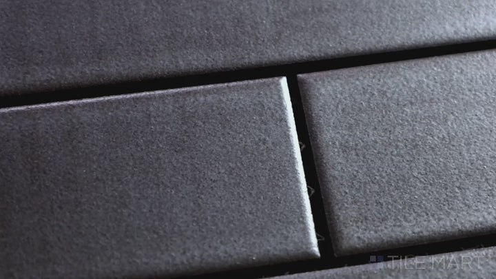 Video of Zenia Gravity Rectangle Matte Glazed Porcelain Mosaic. A soft gray matte mosaic, delivering a contemporary touch with subtle depth and texture.