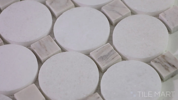 Video of The Finish Line Pale Beige Circular Polished Marble Mosaic. A warm-toned circular marble tile with a glossy polished surface, enhancing both traditional and modern aesthetics.
