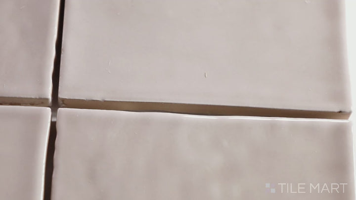 Video of Marin Coastal Cliff 4X4 Gloss Glazed Ceramic. A soft neutral glossy tile in a timeless square shape, inspired by natural stone textures.