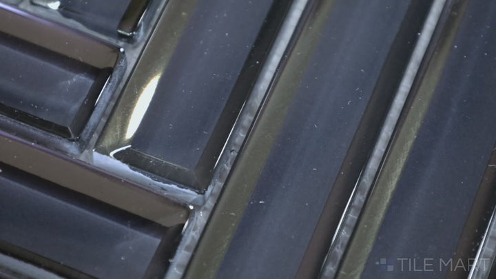 Video featuring Modern Glass Blue Herringbone Glossy Mosaic. A vibrant blue glass tile with a polished glossy finish, designed in a unique herringbone pattern for a modern, dynamic effect.