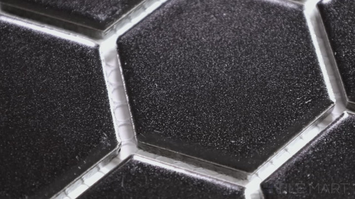 Video of Porcelain Glazed Mosaics Black 2-inch Hexagon Matte. A deep black matte porcelain hexagonal mosaic, delivering bold contrast and a sophisticated design.