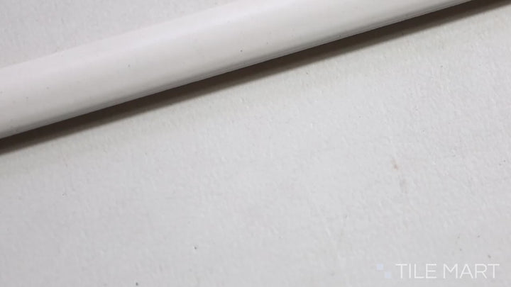 Soft matte surface of Manhattan Ceramic Maddison 0.5X12 Demi-Bullnose styled in a serene, modern environment