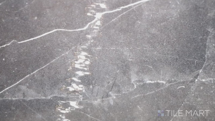 Video featuring Tele Di Marmo Revolution Calacatta Black 24X48 Polished Porcelain. A high-gloss black marble-inspired tile with bold white veining for an ultra-luxurious statement.