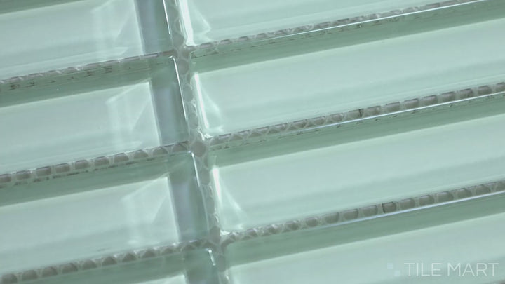 Video of Glass Pastel Green Grid Glossy Mosaic. A gentle pastel green glass mosaic with a glossy surface, featuring a grid layout that enhances its soft, contemporary style.