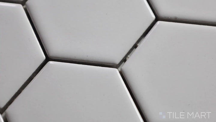 Video showcasing Retro White 2" Hexagon Glossy Porcelain Mosaic. A timeless white hexagonal mosaic with a glossy finish, ideal for vintage and contemporary designs.