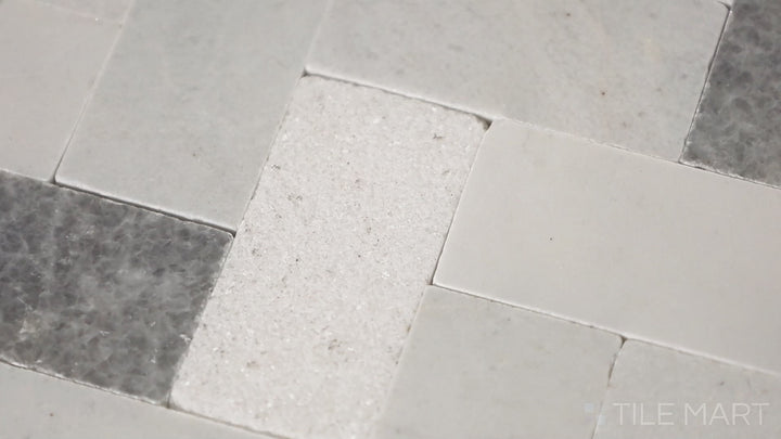 Video of Minute Mosaix Carrara White Herringbone Marble, Limestone Mosaic. A classic Carrara marble mosaic in a stylish herringbone pattern, perfect for elegant spaces.