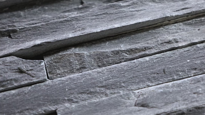 Video showcasing Contemporary Mini Ledgestone Charcoal 6x24 Natural Stone. A deep charcoal-toned natural stone tile with a stacked ledgestone design, adding depth and rustic character.