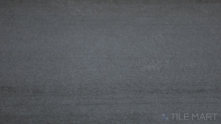 Video featuring Flow Dark Gray 12X24 Matte Porcelain Tile. A deep charcoal gray tile with a rich matte texture, enhancing contemporary aesthetics.