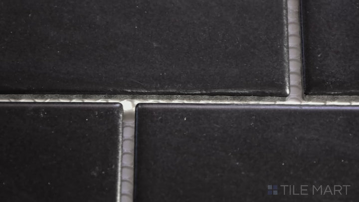 Video featuring Domino Black Rectangle Matte Porcelain Mosaic. A deep black rectangular tile with a matte finish, creating a refined and bold aesthetic.