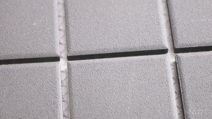 Video featuring Solids Black 2-inch Square Matte Porcelain Mosaic. A deep black matte porcelain square mosaic, bringing bold contrast and timeless elegance.