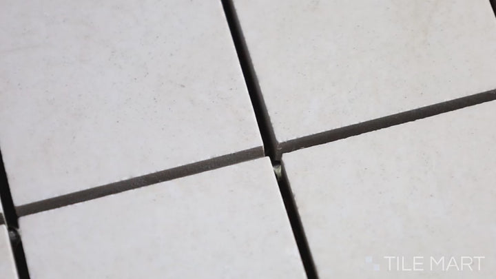 Video highlighting Lugano Marfil 2-inch Square Polished Porcelain Mosaic. A beige-toned polished porcelain mosaic with delicate veining, creating a seamless and timeless appeal.