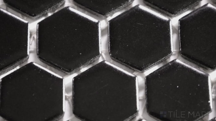 Video showcasing Porcelain Glazed Mosaics Black 1-inch Hexagon Matte. A bold black matte porcelain hexagonal mosaic, adding a sleek and modern touch to any space.