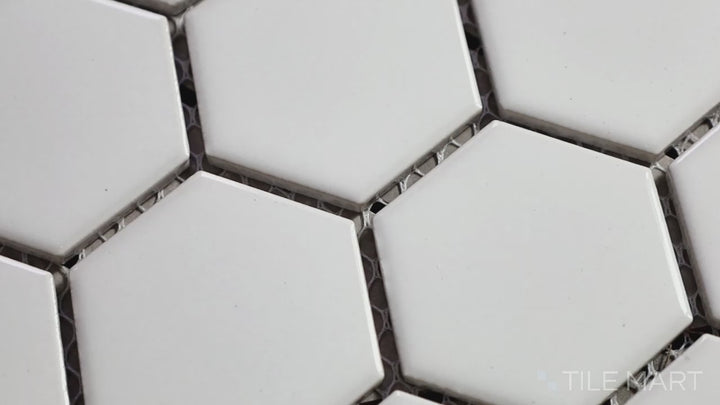 Video featuring Domino White 2" Hexagon Glossy Porcelain Mosaic. A crisp white hexagonal tile with a polished surface, enhancing brightness in any space.