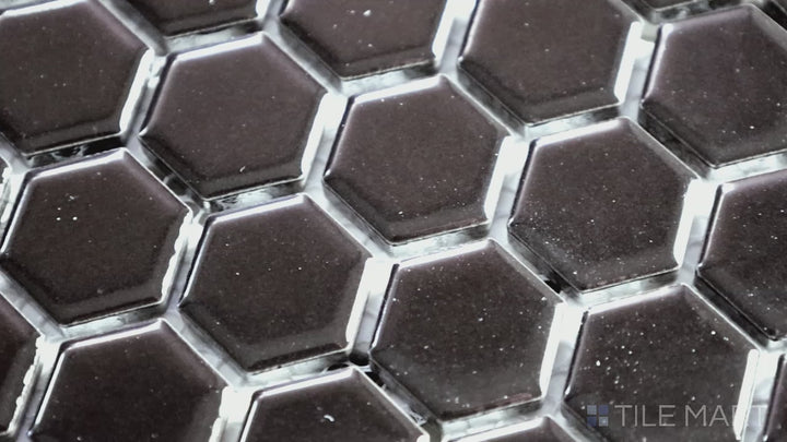 Video showcasing Domino Black 1" Hexagon Glossy Porcelain Mosaic. A sleek, small-format hex tile with a high-gloss finish for a modern aesthetic.