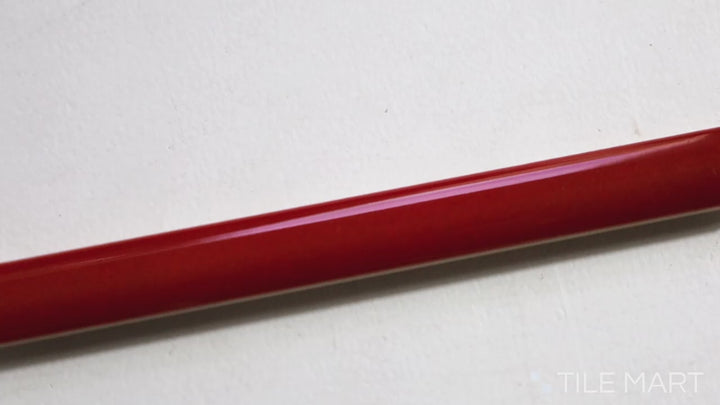 Video of Village Volcanic Red 0.5X8 Glossy Ceramic Jolly Trim. A fiery red trim tile with a glossy finish, ideal for vibrant, eye-catching edges.