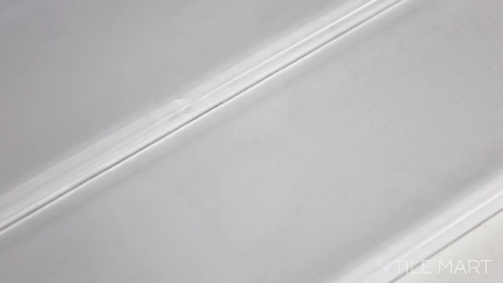 Video showcasing Glass Pastel White 3x12 Glossy. A crisp pastel white glass tile with a high-gloss surface, offering a clean, minimalist look with a smooth, reflective finish.