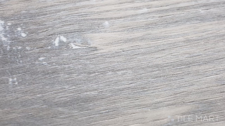 Video featuring Cyrus Finely 7X48 Low Gloss Luxury Plank Vinyl. A classic wood-look luxury plank with a smooth matte texture and subtle wood grain pattern.