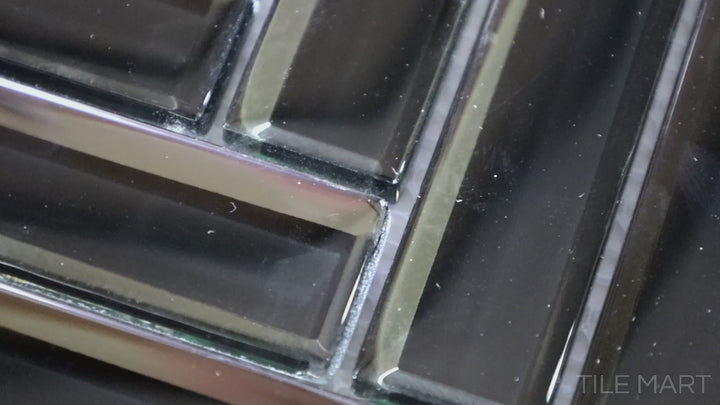 Video showcasing Modern Glass Black Herringbone Glossy Mosaic. A striking black glass tile with a glossy sheen, arranged in a sophisticated herringbone pattern for a bold, stylish look.