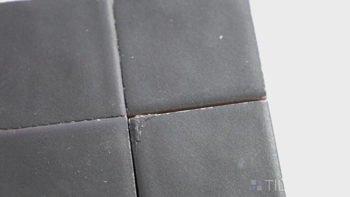 Video of Kasbah Taco Black Hat 1X1 Matte Porcelain Tile. A bold black mini tile with a matte finish, ideal for creating high-contrast mosaic effects.