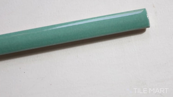 Video highlighting Village Emerald Green 0.5X8 Glossy Ceramic Jolly Trim. A vibrant green trim tile with a glossy finish, adding a bold accent to tiled walls.