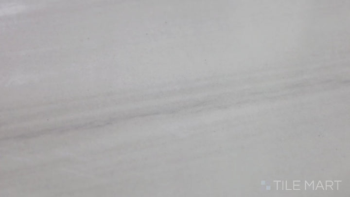 Video featuring Eden Dolomite 12X24 Polished Porcelain. A polished white porcelain tile with subtle gray veins, mimicking the elegance of natural Dolomite marble.