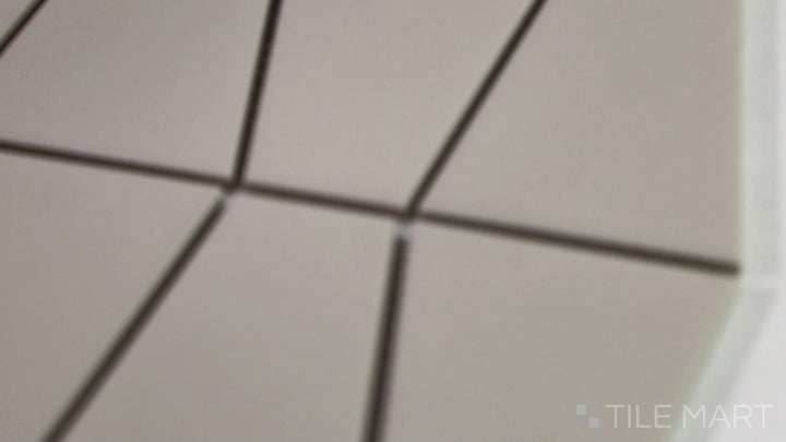 Video showcasing Marin Sand Dollar Trapezoid Matte Glazed Porcelain Mosaic. A warm beige trapezoid tile with a subtle matte finish, creating a soft and inviting ambiance.