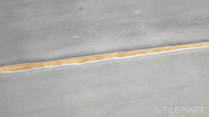 Video showcasing Marin Midnight Tide 2.5X10 Gloss Glazed Ceramic. A deep navy blue glossy tile with a sleek elongated design, adding richness to walls and backsplashes.