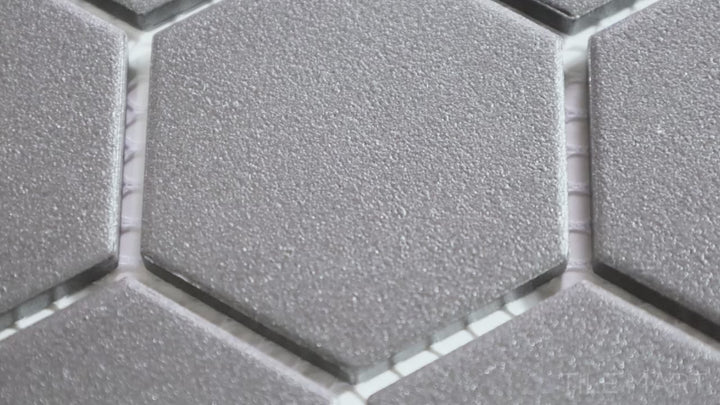 Video highlighting Solids Black 2-inch Hexagon Matte Porcelain Mosaic. A bold black matte porcelain hexagonal mosaic, adding contrast and geometric appeal.