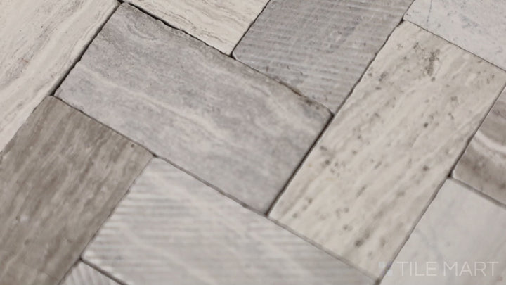 Video showcasing Minute Mosaix Chenille White Herringbone Marble, Limestone Mosaic. A sophisticated herringbone pattern in soft white tones, adding a timeless touch to interiors.