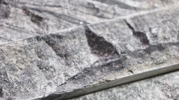 Video showcasing Rockmount Black 6X24 Stacked Stone Panel Splitface Marble. A sophisticated black marble stacked stone panel with natural variations for depth and style.