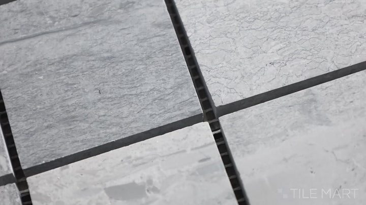 Video of Sto-Re Wooden Blue 2.25" Square Polished Marble Mosaic. A unique Wooden Blue marble mosaic with a polished finish, arranged in large square tiles for a contemporary touch.