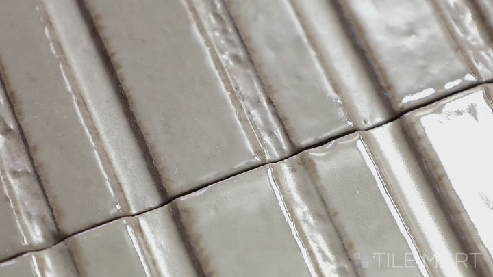 Video featuring Glace Mastice 3X8 Glossy Porcelain. A warm-toned gray glossy tile that complements both traditional and contemporary spaces.