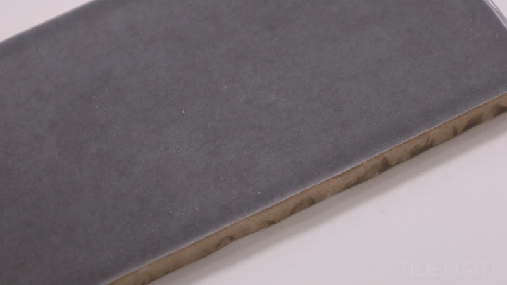 Video showcasing Highland Lake Carbon 3X10 Glossy Ceramic. A deep charcoal tile with a reflective surface, perfect for creating a bold and modern aesthetic.