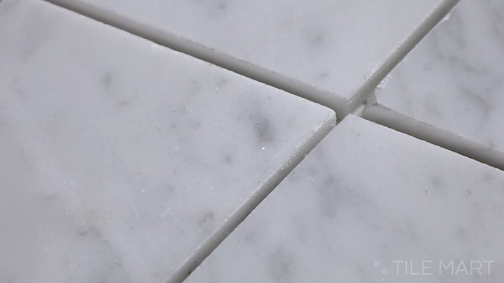 Video highlighting Sto-Re Carrara Rhomboid Polished Marble Mosaic. Classic Carrara marble with a polished surface, crafted into a refined rhomboid pattern for a sophisticated and timeless look.
