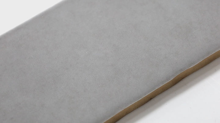 Video highlighting Highland Lake Rain 3X10 Glossy Ceramic. A cool-toned gray-blue tile with a glossy sheen, ideal for refreshing and calming interior designs.