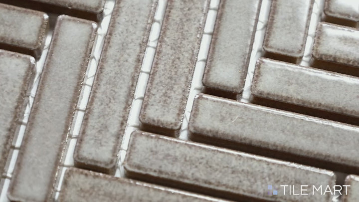 Video showcasing 90° Gray Haze Herringbone Gloss Glazed Porcelain Mosaic. A sleek, glossy gray herringbone tile that adds depth and elegance to modern interiors.