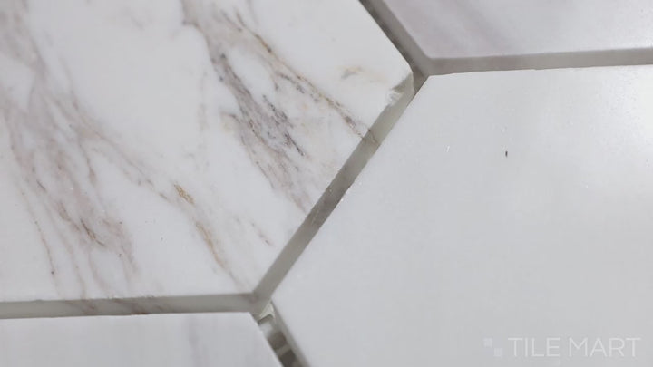 Video highlighting Sto-Re Volakas 4" Hexagon Polished Marble Mosaic. Elegant Volakas marble with a polished finish, designed in a large hexagonal layout to add depth and luxury.