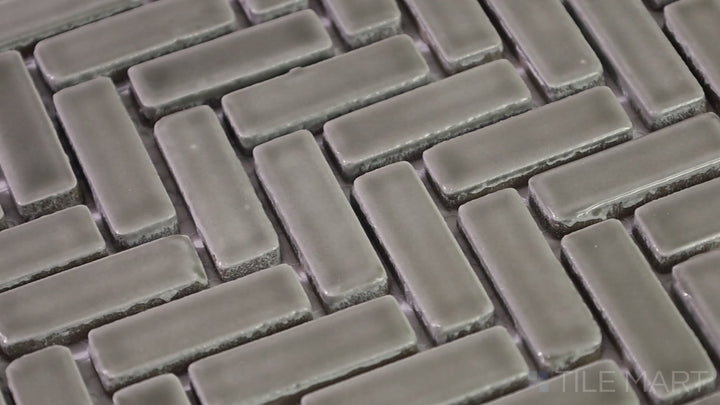 Video featuring Foundations Plains Herringbone Tilt Glossy Ceramic Mosaic. A contemporary ceramic tile with a glossy herringbone tilt design, creating a dynamic and sophisticated aesthetic.